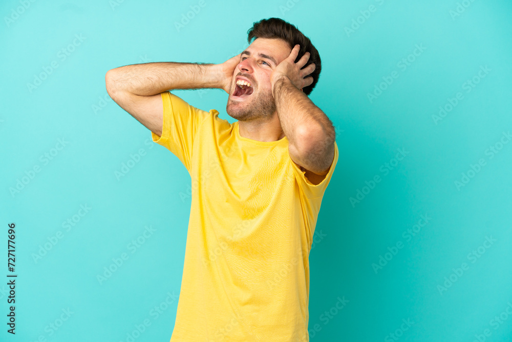 Young caucasian handsome man isolated on blue background stressed overwhelmed Young caucasian handsome man isolated on blue background stressed overwhelmed