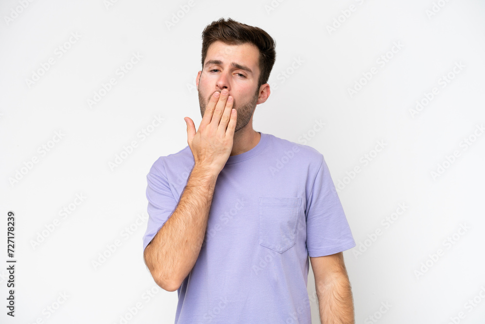Young caucasian man isolated on white background yawning and covering wide open mouth with hand Young caucasian man isolated on white background yawning and covering wide open mouth with hand