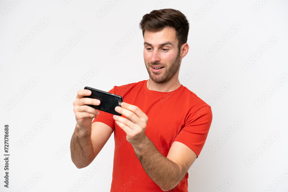 Young caucasian man isolated on white background playing with the mobile phone Young caucasian man isolated on white background playing with the mobile phone