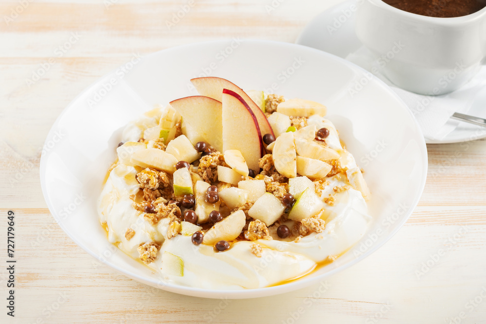 Healthy Βreakfast concept. Yogurt with flakes, fruits and honey on wooden background. Healthy Βreakfast concept. Yogurt with flakes, fruits and honey on wooden background.