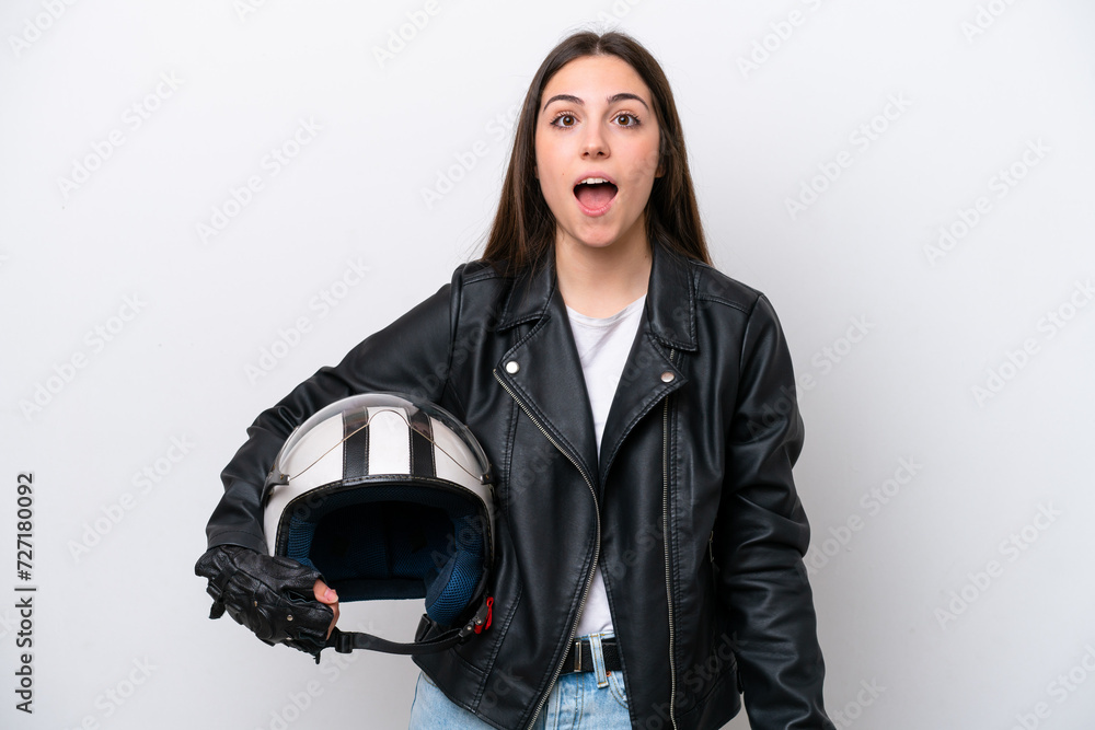 Young girl with a motorcycle helmet isolated on white background with surprise facial expression Young girl with a motorcycle helmet isolated on white background with surprise facial expression