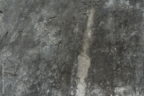 Stone floor has a unique rough surface and dark color. For background and textured.