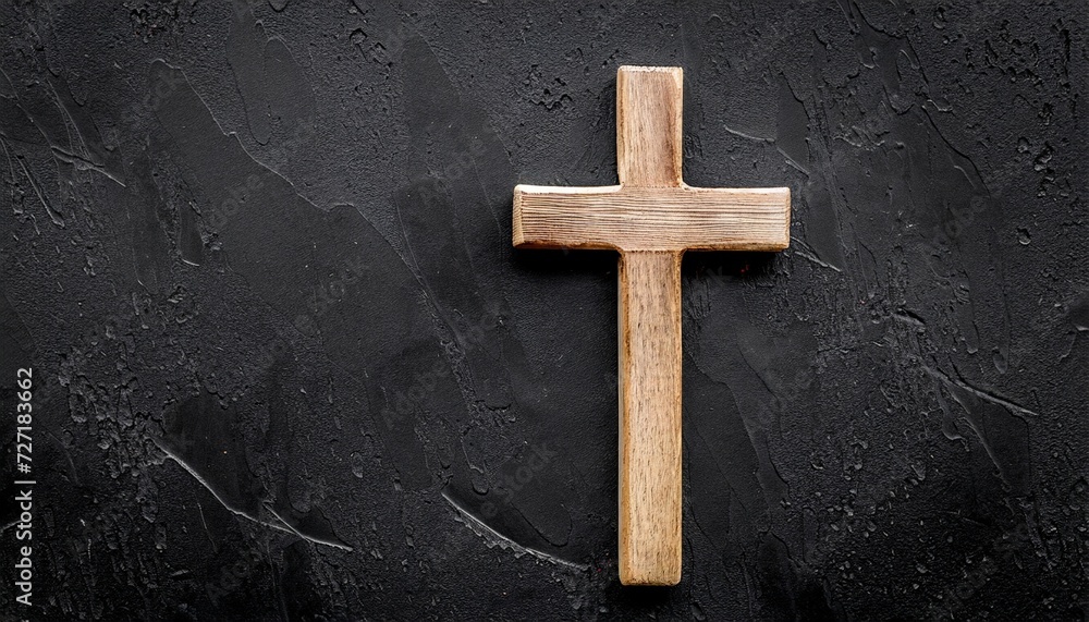 funeral concept wooden cross on black background top view copy space