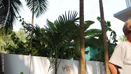 Sleepy, yawning boy of 6-7 years old cannot wake up in any way and walks listlessly down street. 