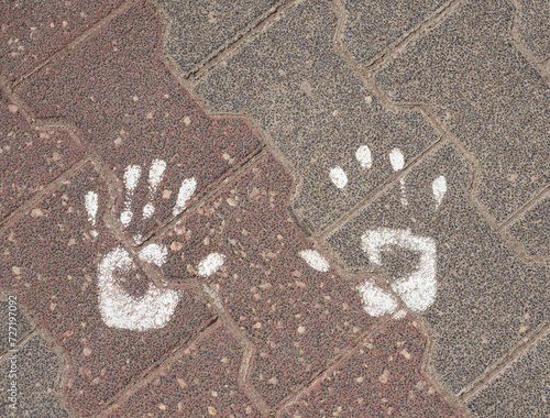 Handprints on stone paving stones with white paint