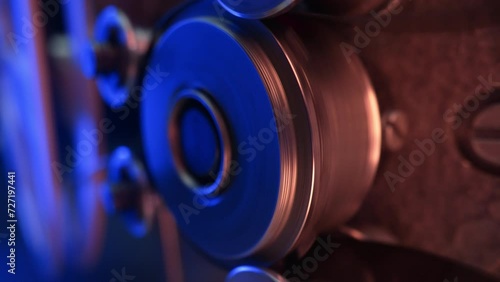 Macro working process of 8mm film projector rotating filmstrip reels. Mechanism  photo