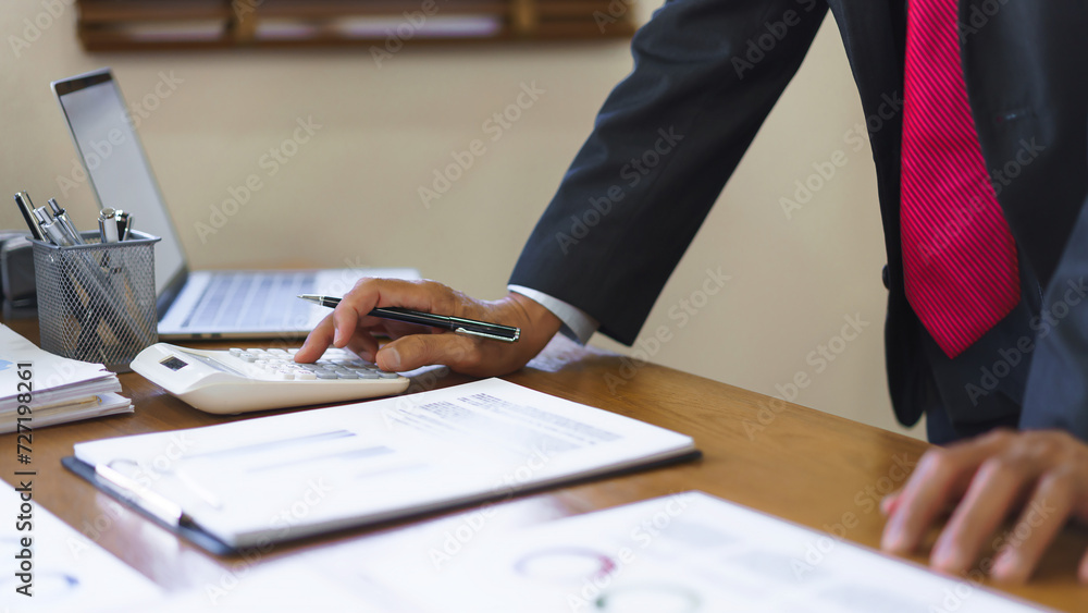 Business analysis concept, Senior businessman use calculator to calculate business cost and profit Business analysis concept, Senior businessman use calculator to calculate business cost and profit