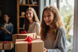 Two teenager girl friends in a house holding a gift