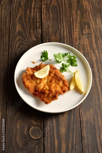 Pork schnitzel with lemon and leaves of parsley