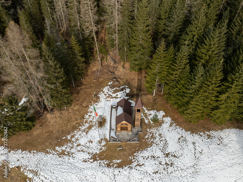 Chiesetta della Madonna della Neve. Panoramic view of the Dolomites mountains in winter, Italy. Ski resort in Dolomites, Italy. Aerial  drone view of ski slopes and mountains in dolomites. photo