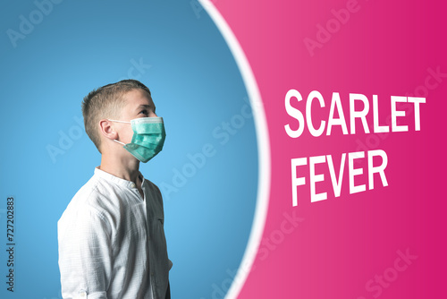 Little boy in a medical mask on a bright background with inscription SCARLET FEVER. photo