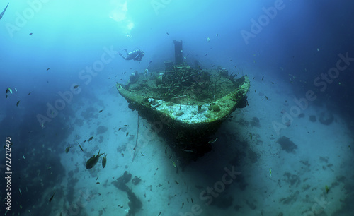 a diver exploring a large sunken ship off the coast of the island of Curacao