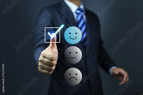 Businessman answer questionnaire on customer opinion feedback by tick correct check mark on smile face icon represent to good and satisfy for service and products