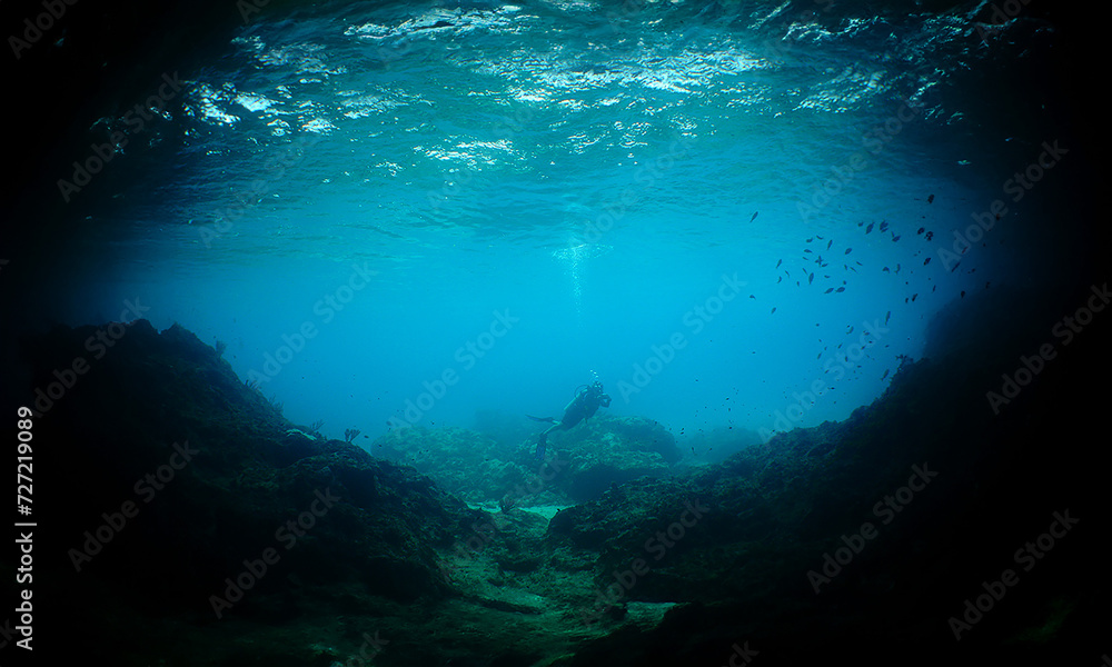 a diver near a cave on the island of Curacao a diver near a cave on the island of Curacao