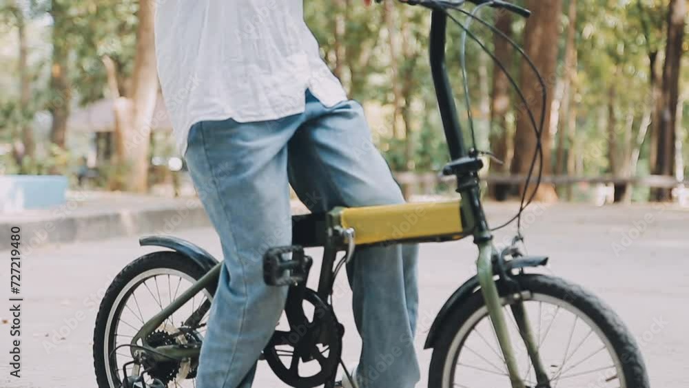 Beautiful happy woman in yellow coat riding bicycle in autumn park. Autumn fashion. Lifestyle. Relax, nature concept. Beautiful happy woman in yellow coat riding bicycle in autumn park. Autumn fashion. Lifestyle. Relax, nature concept.
