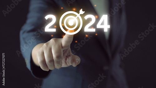 business target and goal on New year 2024 concept, hand holding 2022 virtual screen. new years business. new ideas coming up in the future.
