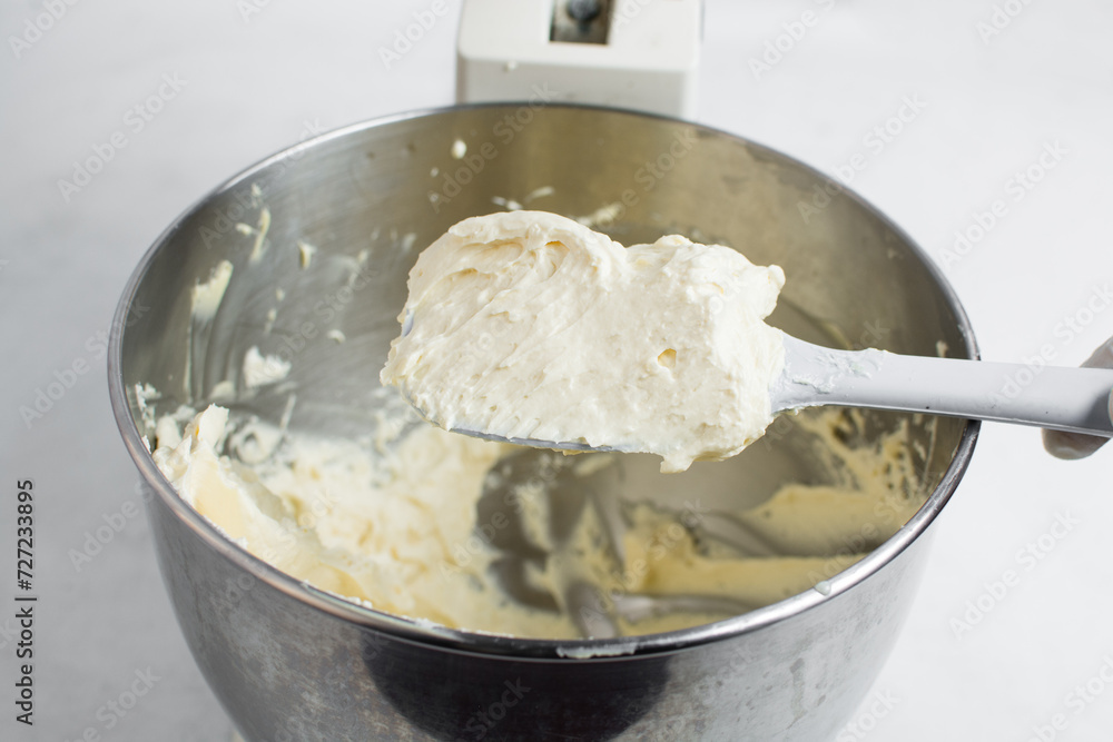 cream buttercream for decorating cake, silky smooth american buttercream on a spatula, overhead view of smooth buttercream cream buttercream for decorating cake, silky smooth american buttercream on a spatula, overhead view of smooth buttercream