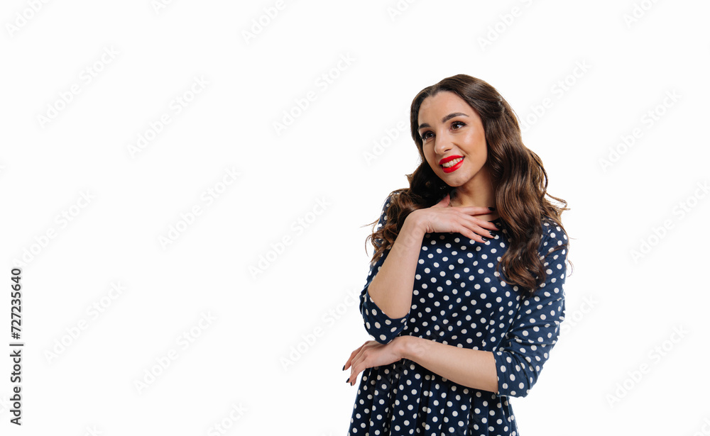 Beautiful young woman in blue dress is standing and smiling on white background Beautiful young woman in blue dress is standing and smiling on white background