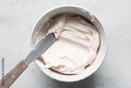 pink buttercream in a white mixing bowl, American buttercream in a bowl for icing cake, frosting for decorating cake