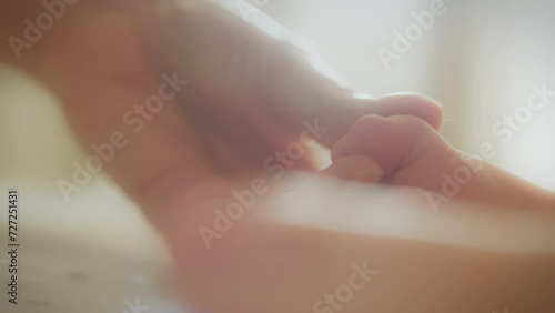 Wallpaper Mural A mother's gentle touch on the arms and legs of a newborn baby, on a bright morning day, a mother spends time with her newborn holding the baby by a cute little leg, A mother touches a small newborn Torontodigital.ca