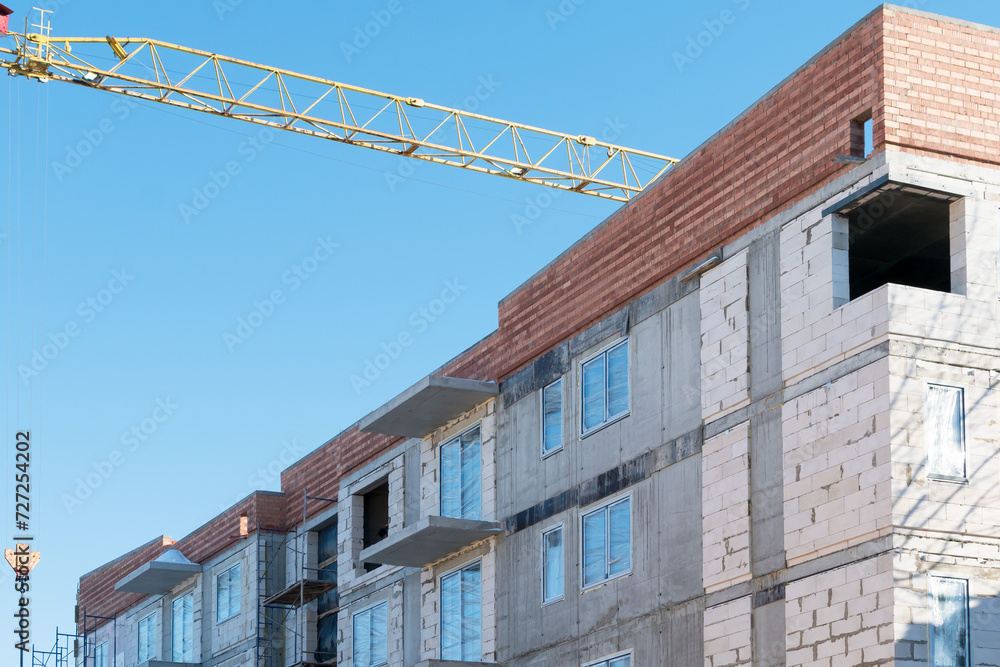 View of an apartment building under construction with balconies View of an apartment building under construction with balconies