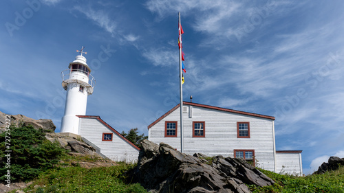 Lobster Cove Head Lighthouse at Gros Morne National Park in Newfoundland, Canada. Overlooking the Gulf of St Lawrence, Bonne Bay and Rocky Harbor. Visitor center with cultural and historical exhibits  photo
