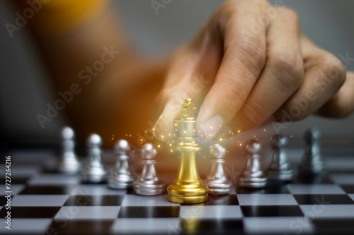 Businessman concept holding golden king chess The concept of delegating leadership, leadership success