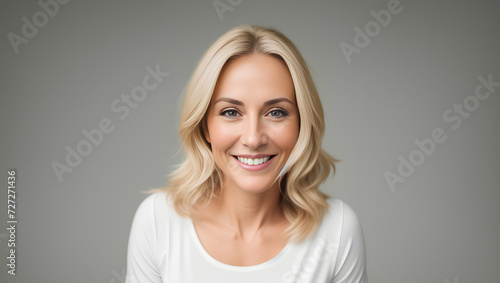 Beautiful female with blond, wavy hair smiling at camera. Isolated background with mockup. Generative AI. © Dawid