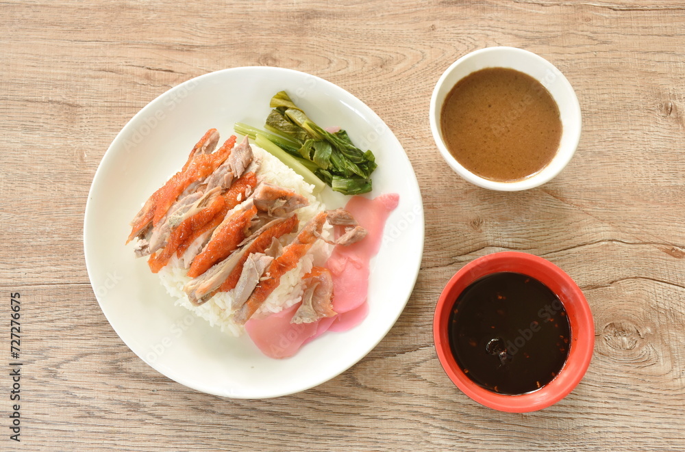 slice roasted duck topping rice with pink pickled ginger and boiled cabbage dressing sweet soy sauce on plate slice roasted duck topping rice with pink pickled ginger and boiled cabbage dressing sweet soy sauce on plate