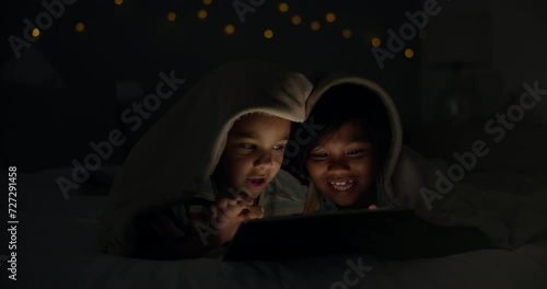 Night, tablet and children on a bed with cartoon, gaming or streaming movie, video of film at home. Family, siblings or kids in a bedroom with love, bonding and digital, search or storytelling app photo