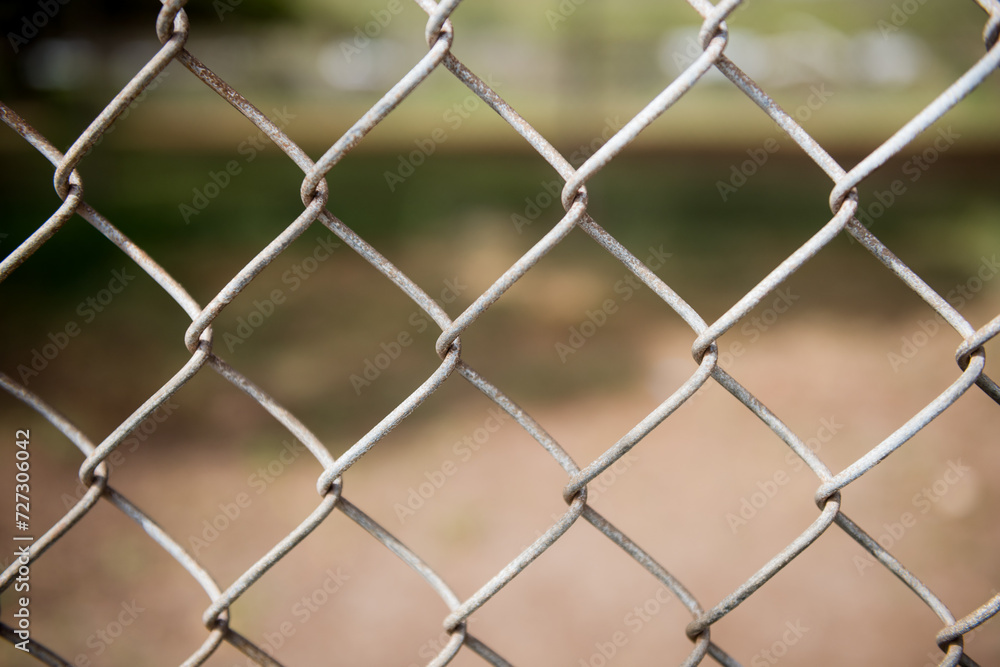 Fence with metal grid in perspective. Metal chain-link fence as the background, street photo, close-up, Fence with metal grid in perspective. Metal chain-link fence as the background, street photo, close-up,