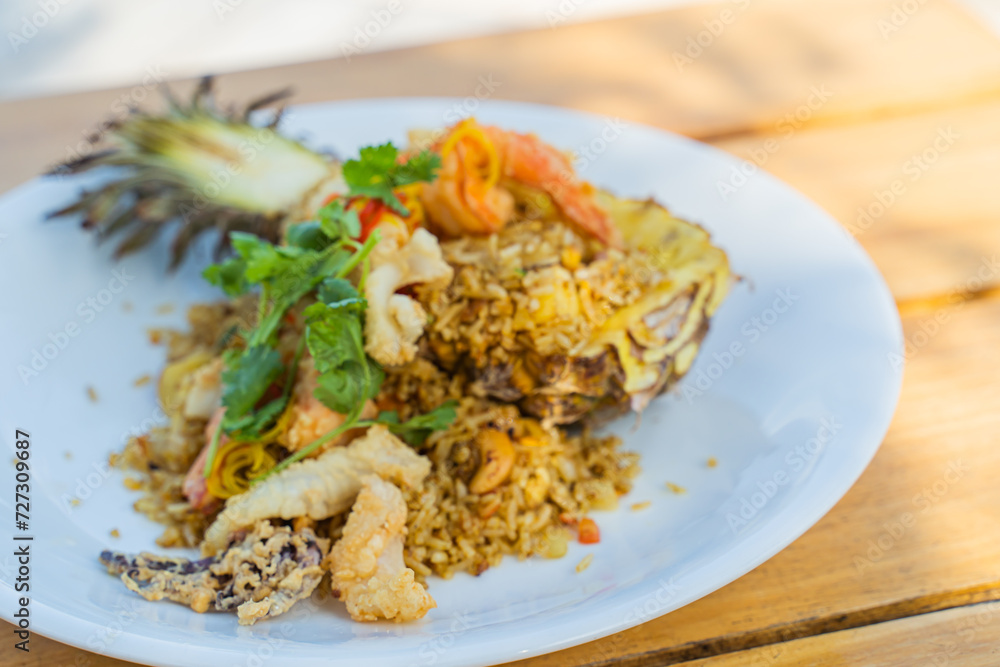 Seafood fried rice in pineapple, appetizing in a cafe next to the sea, Sue Flamingo, Ao Yon Beach, Phuket Thailand
