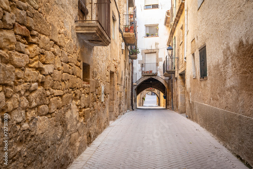 narrow street with traditional old houses in the medieval town of Batea  comarca of Terra Alta  Province of Tarragona  Catalonia  Spain