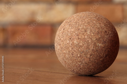 Ball made from wood processing waste on a brown background