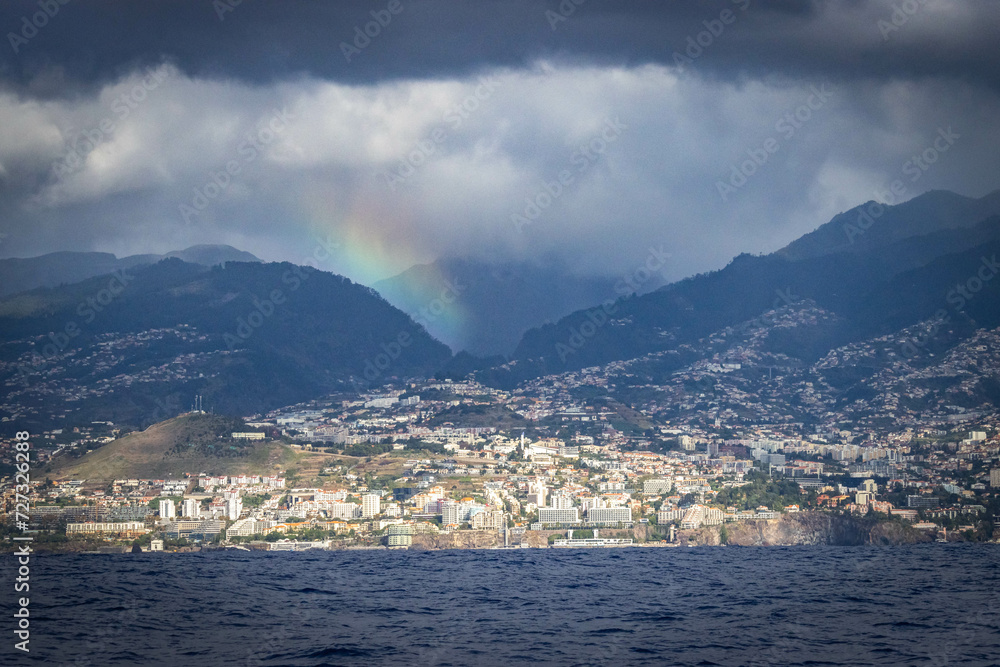 coastline of funchal, madeira, portugal,  panorama, europe, lava formation, cliff, dramatic sky, rainbow