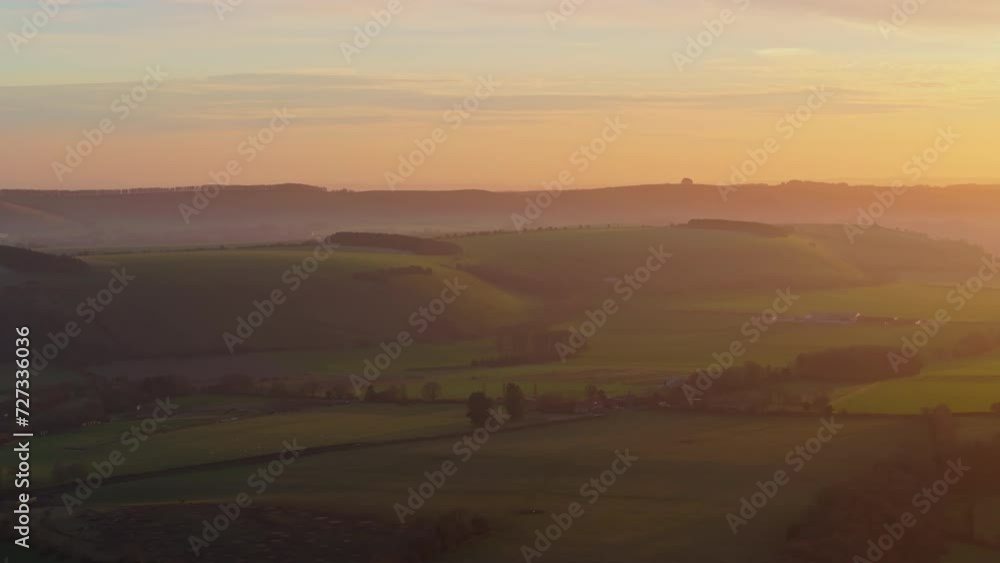 Tracking aerial shot of rolling English countryside at sunset Tracking aerial shot of rolling English countryside at sunset