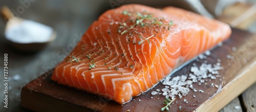 Preparing a salmon by removing its bones and skin from the flesh.