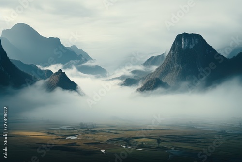 beautiful landscape view of the valley and silhouette mountains in the fog at cold evening