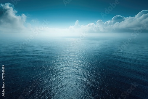 A photograph showcasing a large expanse of water with billowing clouds enveloping the surroundings, A breathtaking aerial view of the deep blue sea meeting the horizon, AI Generated photo