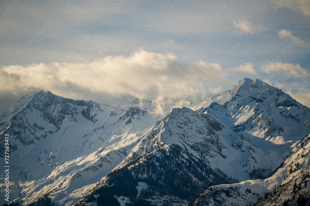 Obraz premium beautiful view of the alps, the hohe tauern in the national park austria, at a cloudy and sunny winter morning