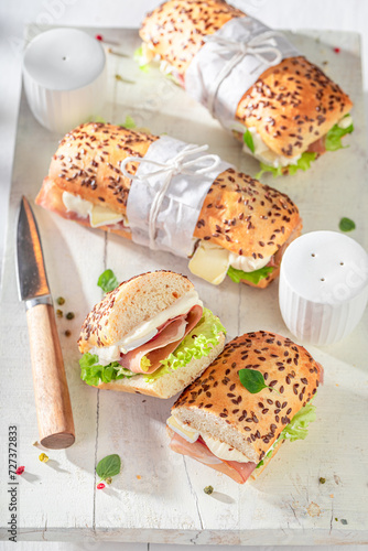 Fresh sandwich with camembert, prosciutto and mayonnaise.