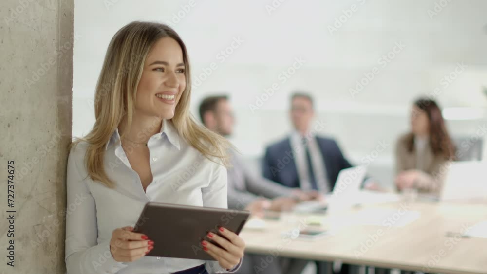 Young business woman with digital tablet standing in the modern office in front of her team Young business woman with digital tablet standing in the modern office in front of her team