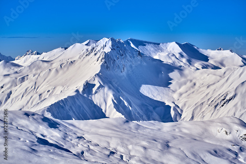 Breathtaking beautiful panoramic view on Snow Alps - snow-capped winter mountain peaks around French Alps mountains, The Three Valleys: Courchevel, Val Thorens, Meribel (Les Trois Vallees), France © udmurd