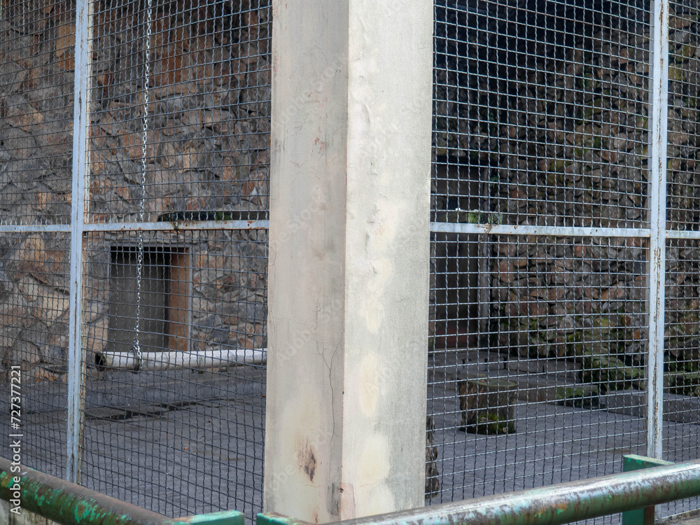 Outdoor fence at the zoo. Empty cages in the zoo. Winter at the zoo. The animals hid. Empty animal enclosure. Outdoor fence at the zoo. Empty cages in the zoo. Winter at the zoo. The animals hid. Empty animal enclosure.