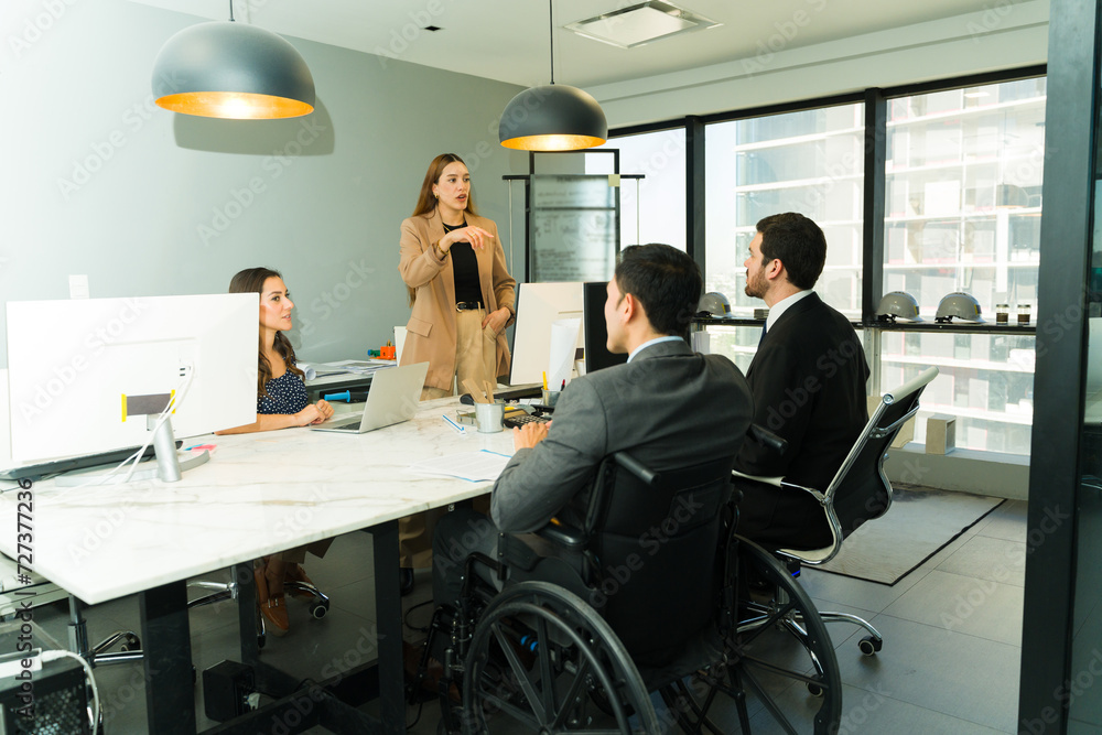 Female boss giving some instructions in a diverse and inclusive office Female boss giving some instructions in a diverse and inclusive office