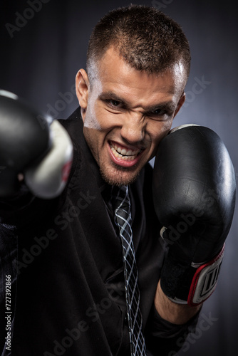 Portrait of businessman with boxing gloves © JUAN