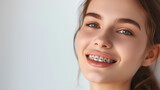 A pretty young girl with braces on her teeth. Dentistry, orthodontics.