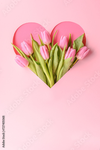 a bouquet of pink tulips in a heart on a pink background, a romantic greeting for the holiday, Mother's Day