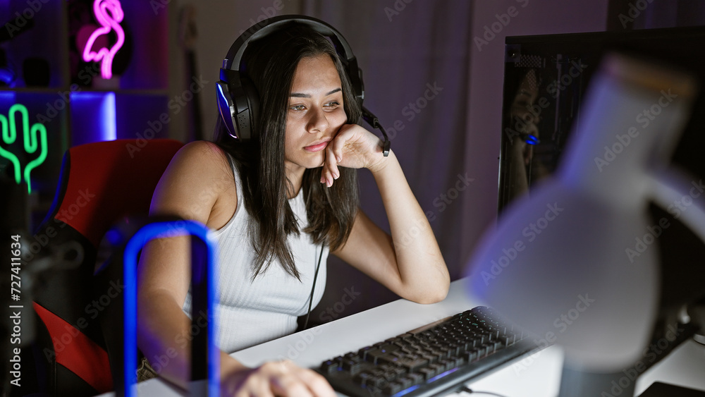 Young beautiful hispanic woman streamer tired using computer at gaming room Young beautiful hispanic woman streamer tired using computer at gaming room