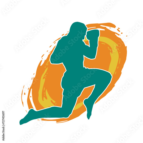 Silhouette of a kickboxer athlete in action pose. Silhouette of a sporty man doing kicking pose.